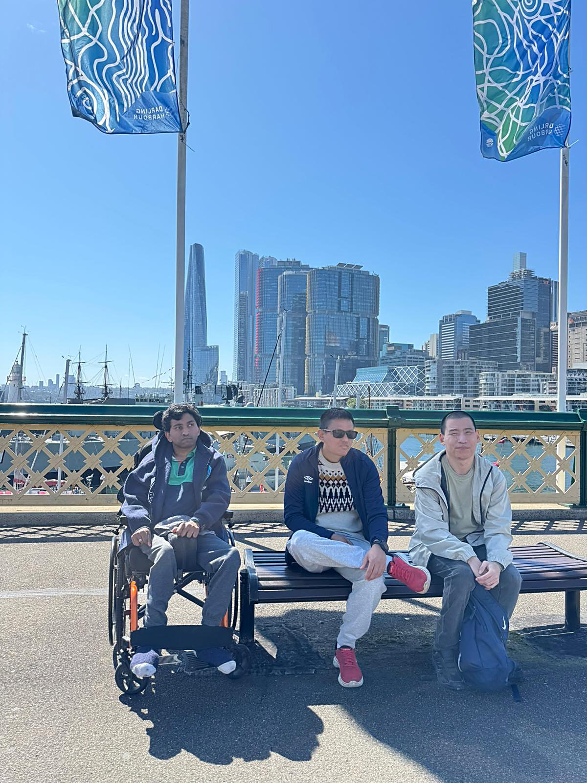 Enable Hub participants and support team at Darling Harbour, with Sydney's skyline behind