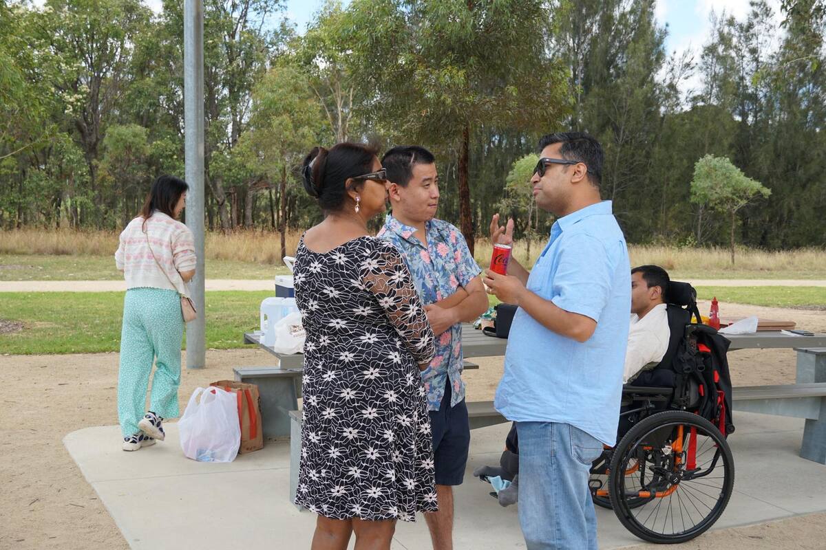 Enable Hub participants and support workers chatting together at a community event